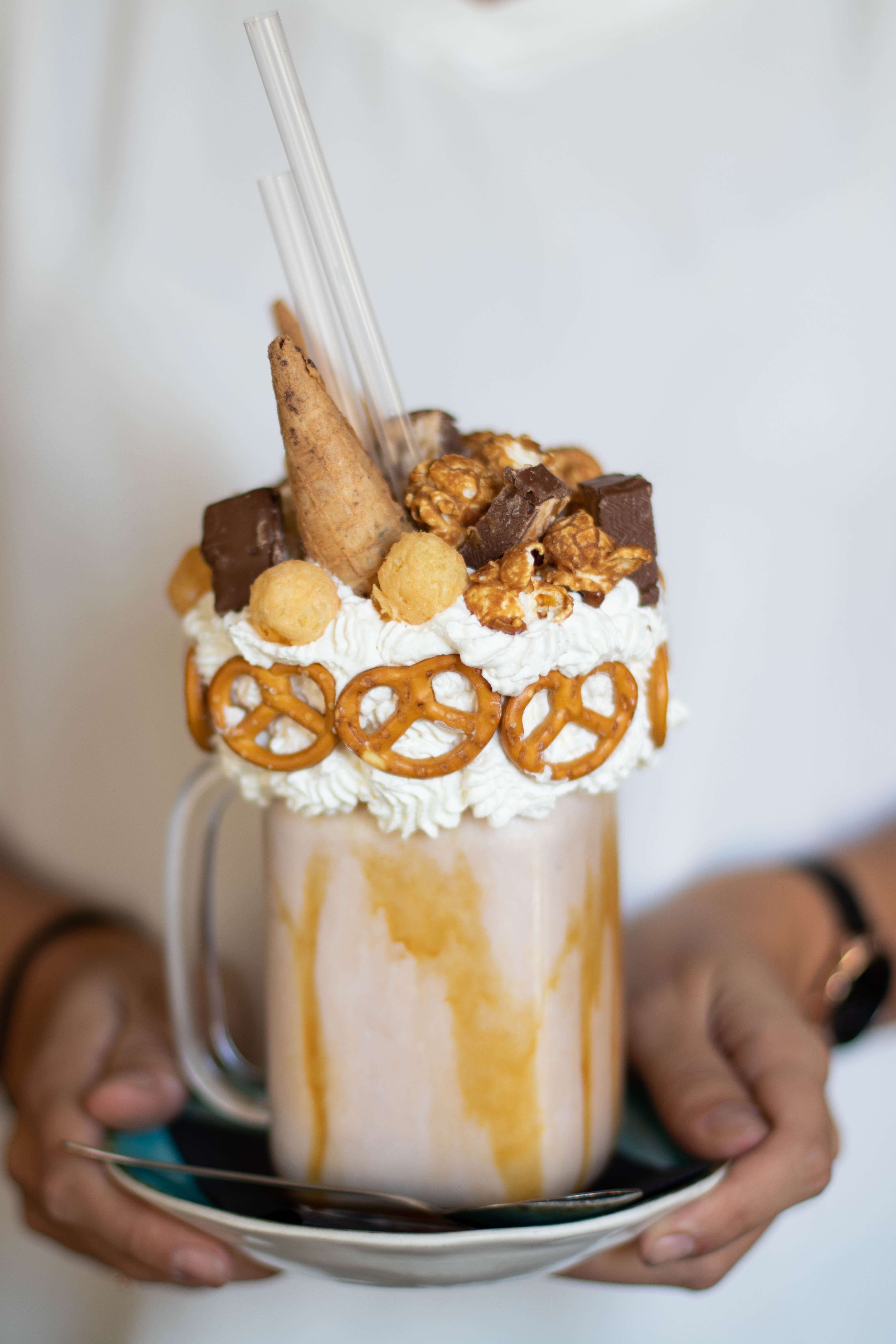 Frozen-bottle-img Person Holding Saucer With Mug of Chocolate Ice Cream Coffee